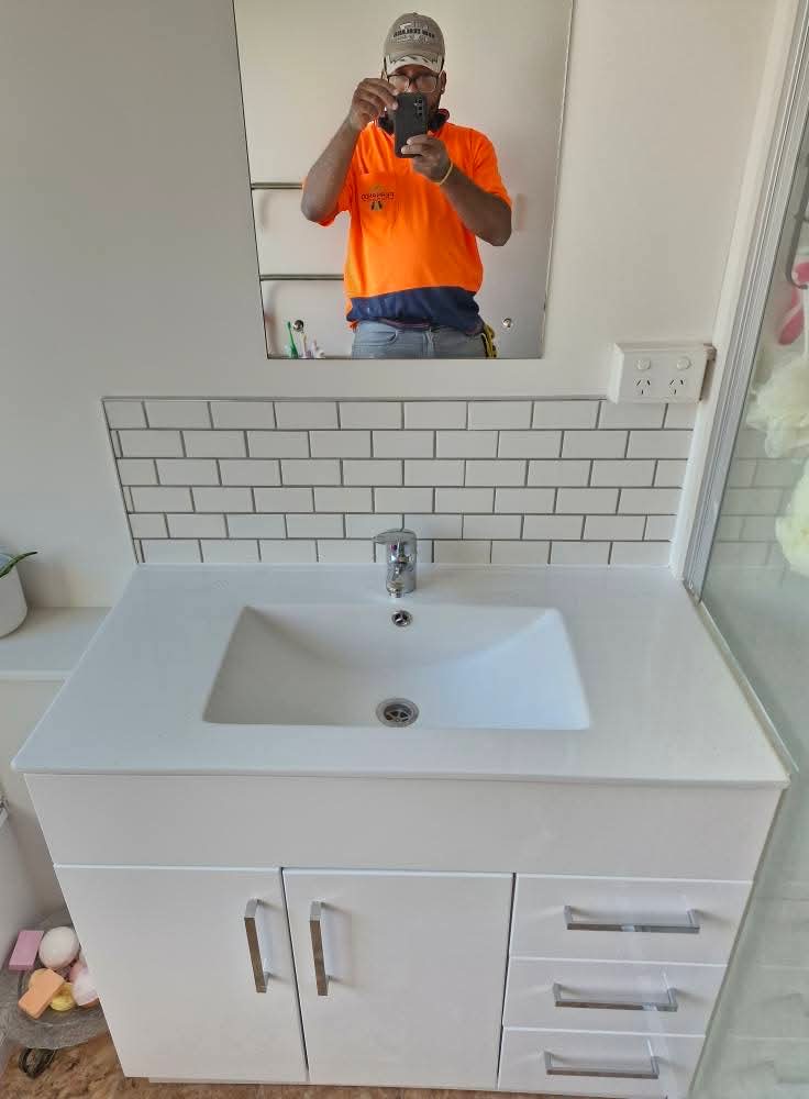 Fernando, wearing a hi-vis shirt, on a recently tiled job