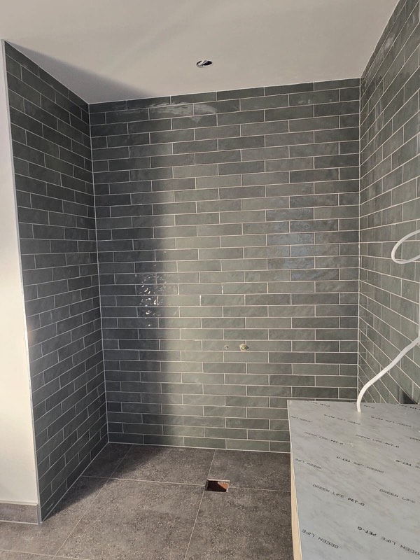 Green-grey subway tiled ensuite shower walls
