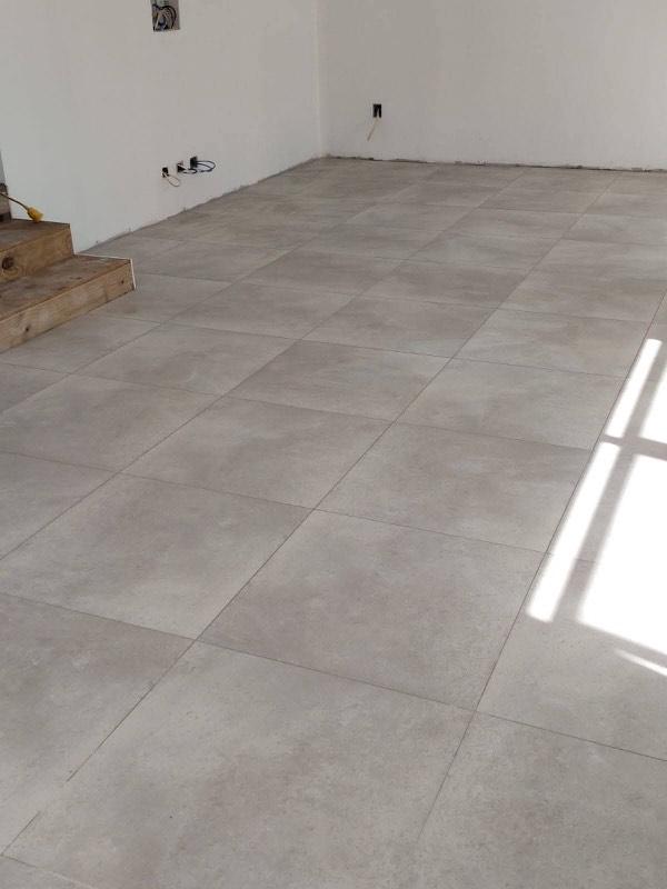 Large-format grey floor tiles in a bright open room
